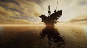 Offshore Jack Up Rig in The Middle of The Sea at Sunset Time photo