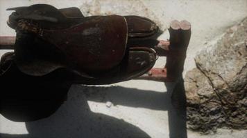 Rider Leather Saddle on fence in desert photo