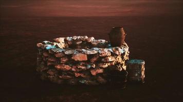 old stone water well in the desert photo