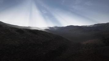 Sun Rays over Mountains in a Valley photo