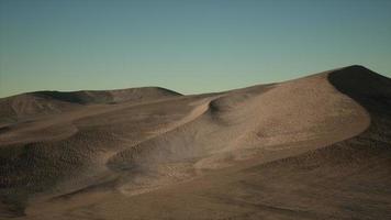 Aerial view on big sand dunes in Sahara desert at sunrise photo