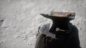 Old anvil attached to a stump photo