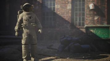 Lost Astronaut near Abandoned Industrial Buildings of Old Factory photo