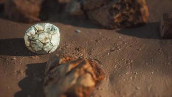 old football ball on the sand beach photo