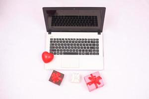 laptop and gitf box for christmas and new year celebration isolated on white background photo