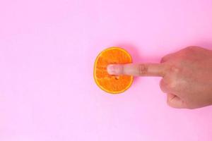sex education with oranges isolated on pink background