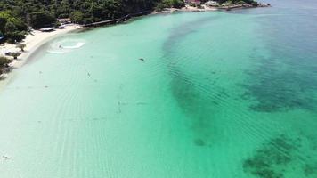 bovenaanzicht vanuit de lucht van en prachtig zeestrand bij bovenaanzicht op de zomer, luxe eilandparadijs voor toerismereizen op zomervakantie. video