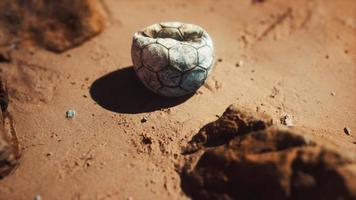 old football ball on the sand beach photo