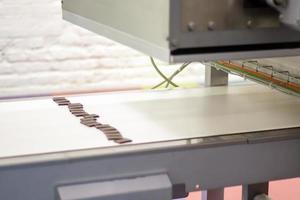 Line for the production of chocolate in an industrial factory. Automatic process in the production line of sweets. Images from the chocolate factory during production. Conveyor belt with sweets. photo