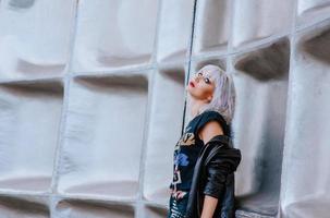 Portrait of stylish blonde grunge blonde woman on the futuristic background photo