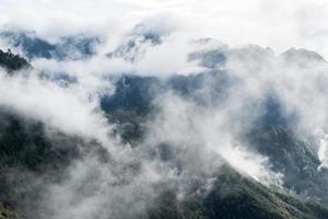 Scenery of Tram Ton Pass or O Quy Ho Pass is mountain pass winding in valley with foggy at Sapa, Northwest Vietnam photo