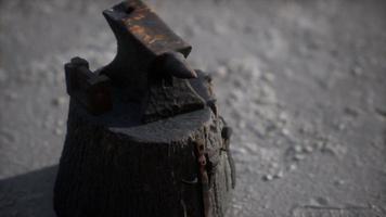 Old anvil attached to a stump photo