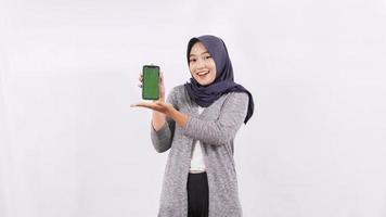 asian woman showing smartphone screen isolated on white background photo