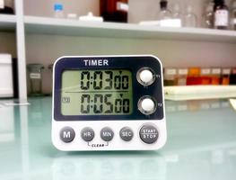 Closeup stop watch in laboratory. Timer. Laboratory test time counting concept.Stopwatch. photo