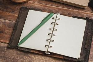 open blank planner on wooden working desk photo