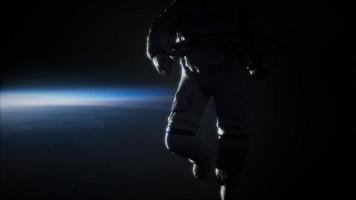 Astronaut in outer space against the backdrop of the planet earth photo