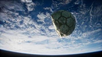 old soccer ball in space on Earth orbit photo