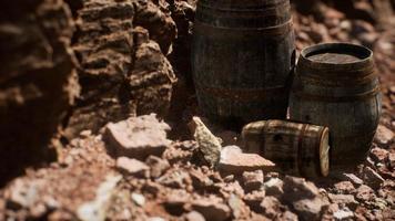 old wooden vintage wine barrels near stone wall in canyon photo