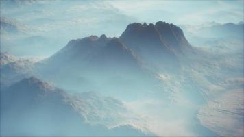 Distant mountain range and thin layer of fog on the valleys photo