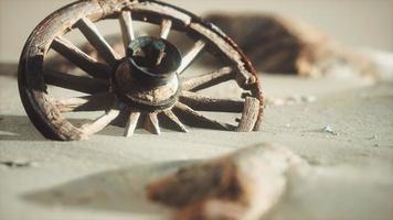 Large wooden wheel in the sand photo