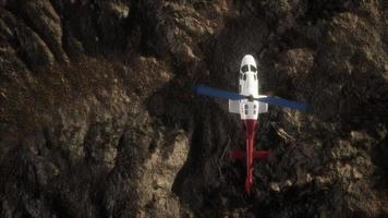 slow motion helicopter above rocky desert photo