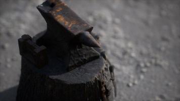 Old anvil attached to a stump photo