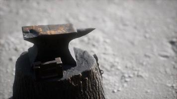 Old anvil attached to a stump photo