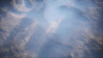 Distant mountain range and thin layer of fog on the valleys photo