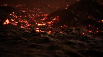 Red Orange vibrant Molten Lava flowing onto grey lavafield and glossy rocky land photo