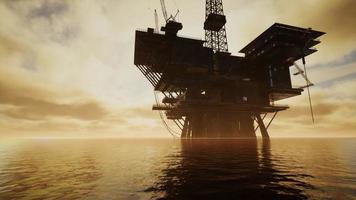 Offshore Jack Up Rig in The Middle of The Sea at Sunset Time photo