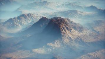 Distant mountain range and thin layer of fog on the valleys photo