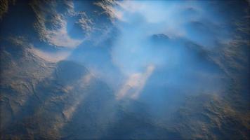 Distant mountain range and thin layer of fog on the valleys photo