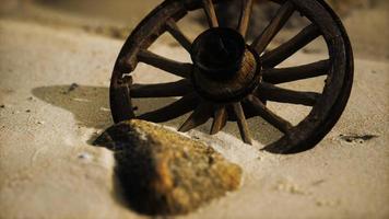 Large wooden wheel in the sand photo