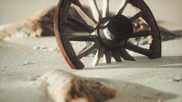 Large wooden wheel in the sand photo