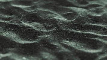 olas de arena negra como fondo foto