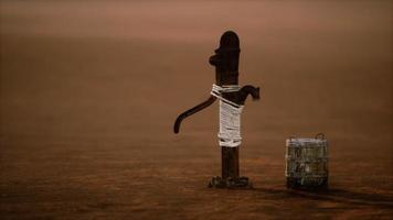 old rusted metal well in desert photo