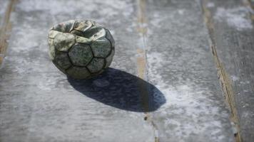 Old soccer ball the cement floor photo