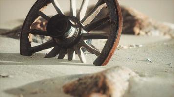 Large wooden wheel in the sand photo