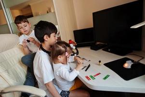 Kids using microscope learning science class at home. photo