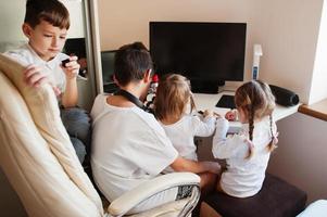 Kids using microscope learning science class at home. photo