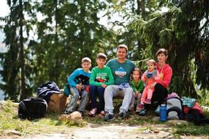 Family with four kids resting in mountains. Travel and hiking with childrens. photo