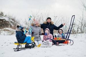 familia escandinava con bandera de suecia en el paisaje sueco de invierno. foto