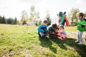 Father hold kitty with four kids in mountains. Family love with nature. photo