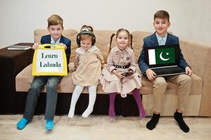 Four kids show inscription learn lahnda. Foreign language learning concept. Pakistan flag. photo