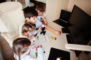 Kids using microscope learning science class at home. photo
