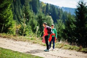 Mother with son travel to nature. Relaxing on the mountain. Feel freedom. photo