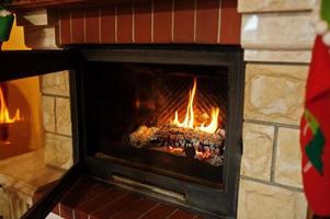 Home fireplace in warm living room on winter day. photo