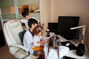 Kids using microscope learning science class at home. photo