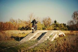 Enduro racer sitting on his motorcycle photo