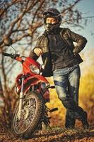 Motorcycle rider stay at sunset with him enduro bike